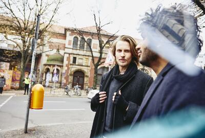 Two men walking on the streets.