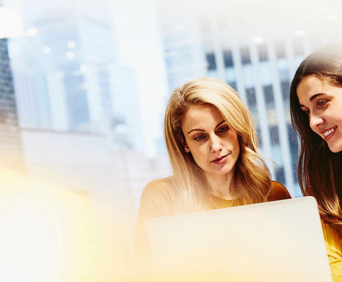 females sitting working on laptop