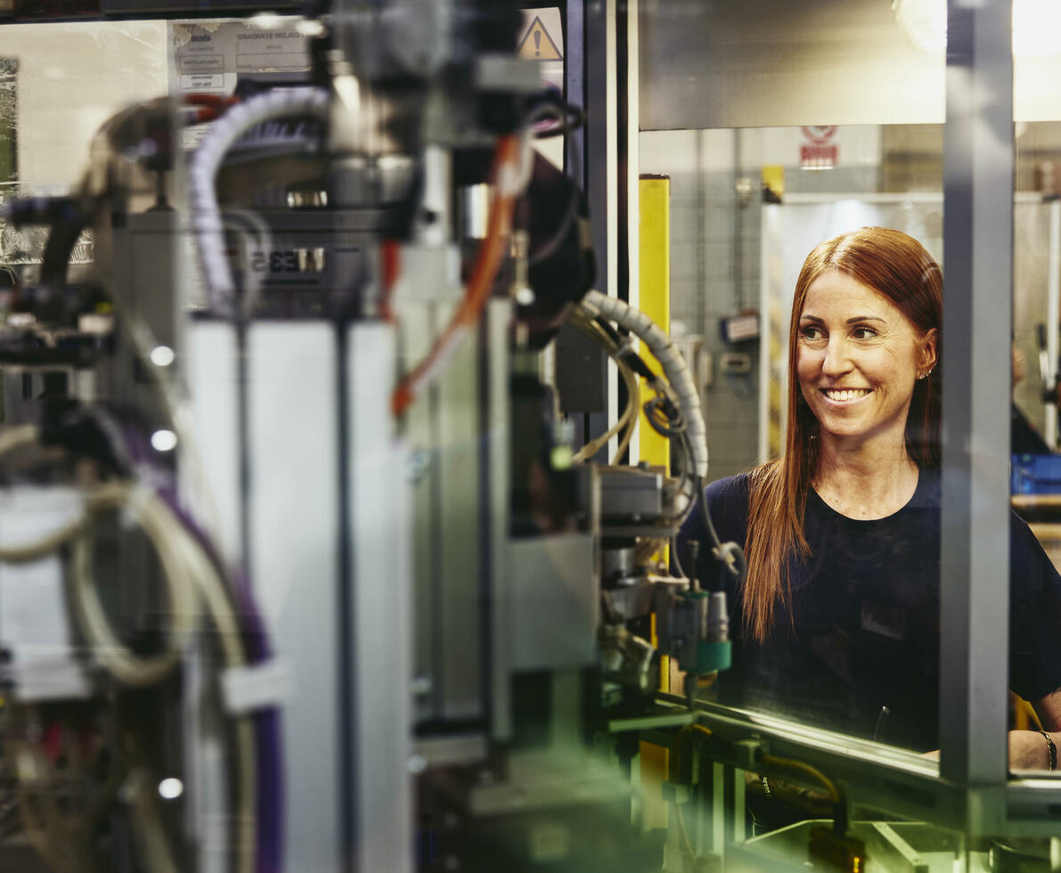 Woman operating a machine on a production site. 