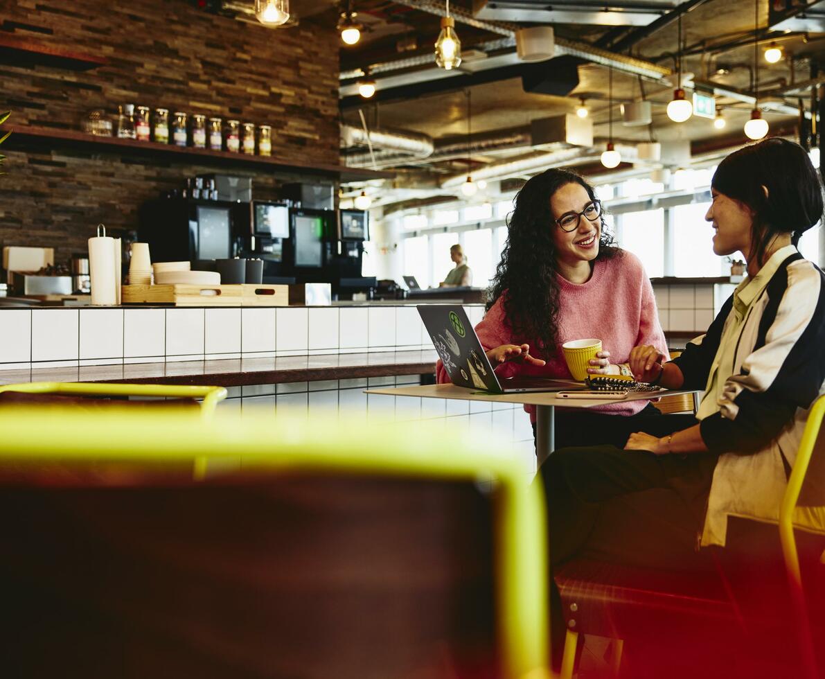 two woman sitting in bar